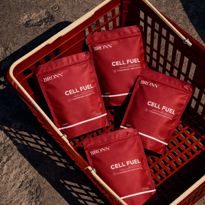 Red 'BRONN CELL FUEL' packets in a red basket on a textured surface