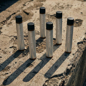 White cylindrical objects with black caps on a concrete surface