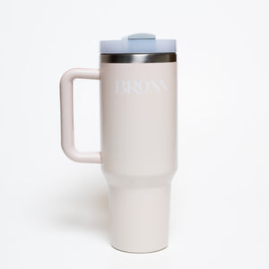 White travel mug with handle on a white background