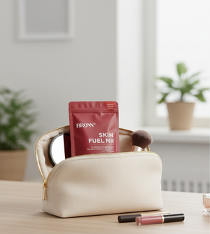 Beige makeup bag with a red packet labeled 'Bronn Skin Fuel NR' on a wooden surface.