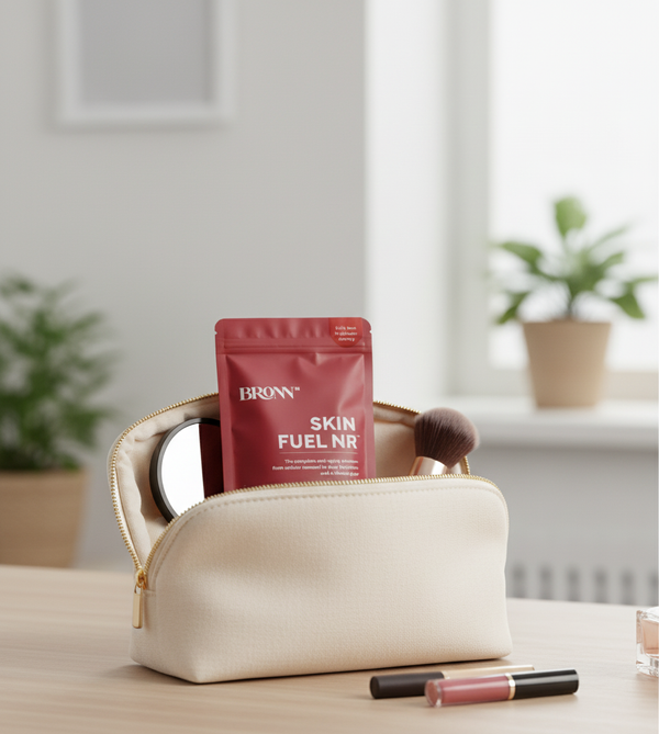 Beige makeup bag with a red packet labeled 'Bronn Skin Fuel NR' on a wooden surface.