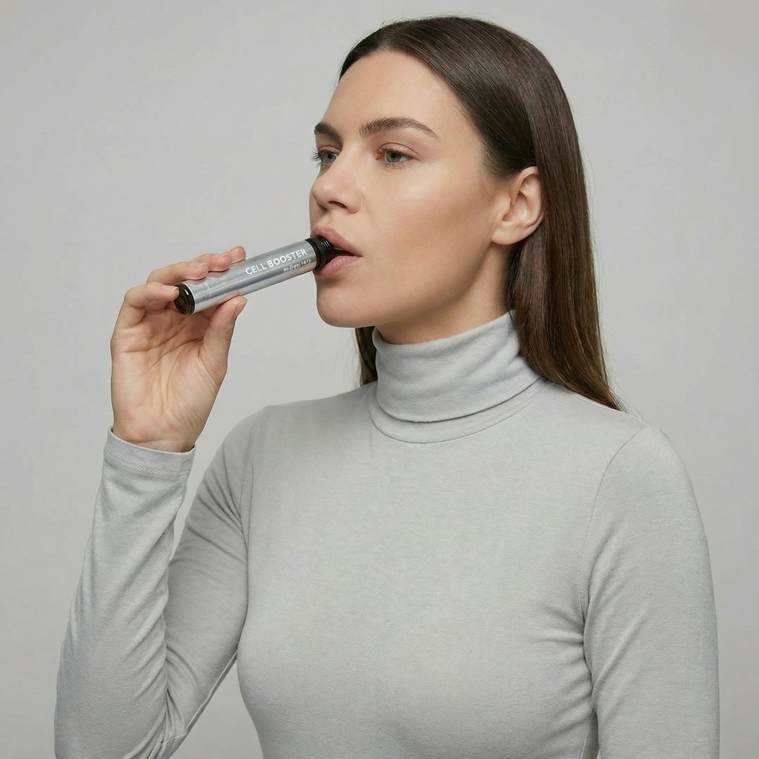 Woman using a lip balm with a gray background