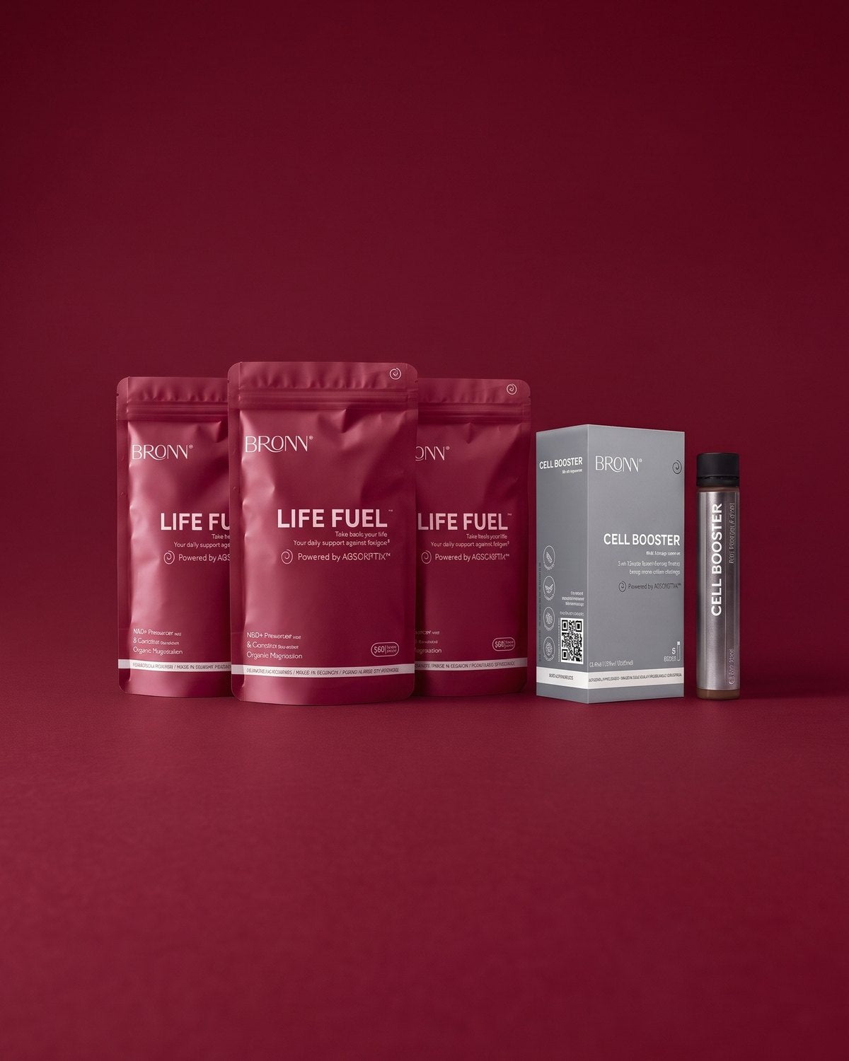 Three pouches of LIFE FUEL&trade; and a CELL BOOSTER&trade; 6-pack on bordeaux