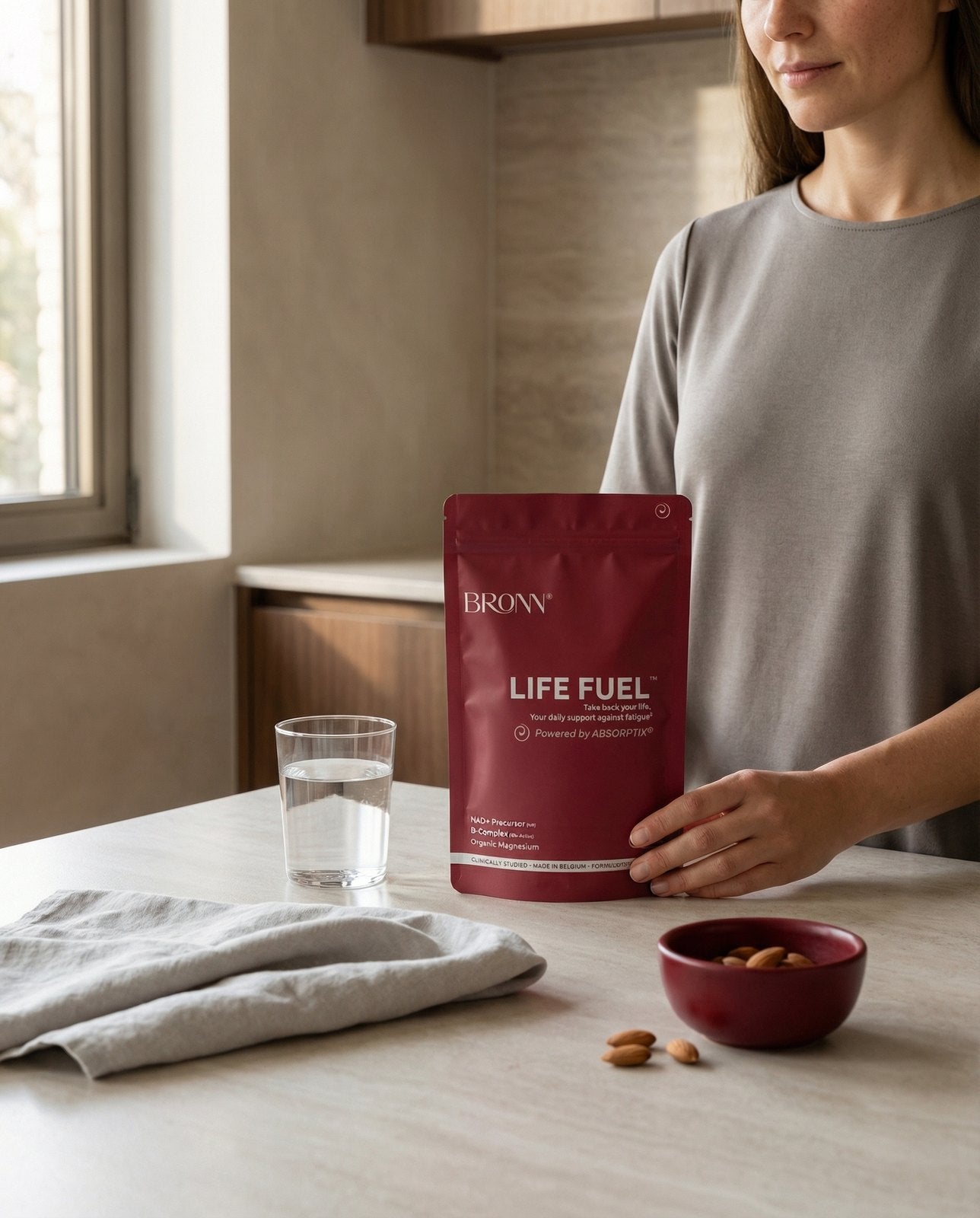 A woman with a pouch of LIFE FUEL&trade; at home